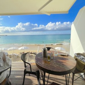 Beach bar in Saint Martin overlooking white beach parasols for video production