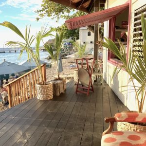 Colourful lively beach bar with stairs to bthe sea and jetty as backdrop in photo shooting