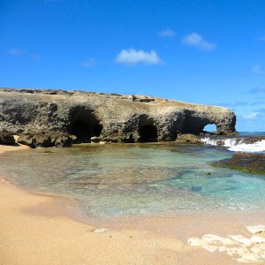 Outstanding rock formation on wide spread beach with turquoise water fountains in Barbados