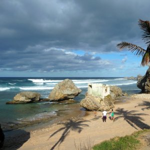 Rustic all natural beach feel with massive rocks and surfer waves for video production