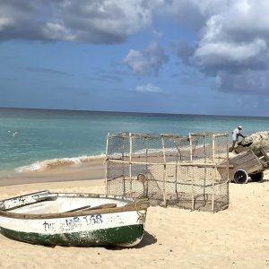 Video scene with fisherman and boat on Caribbean seashore