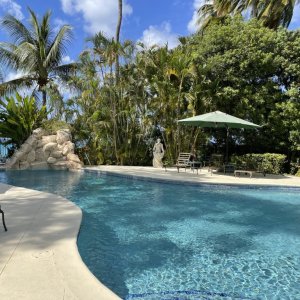 Swiming pool on luxury garden veranda of colonial mansion with vegetation around and access to the sea