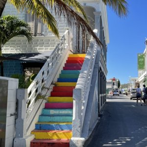 Entertainment center of St. Martin showing street and colored stairs leading to patio of bar in grand case